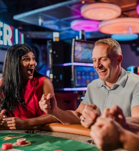 people cheering playing table games